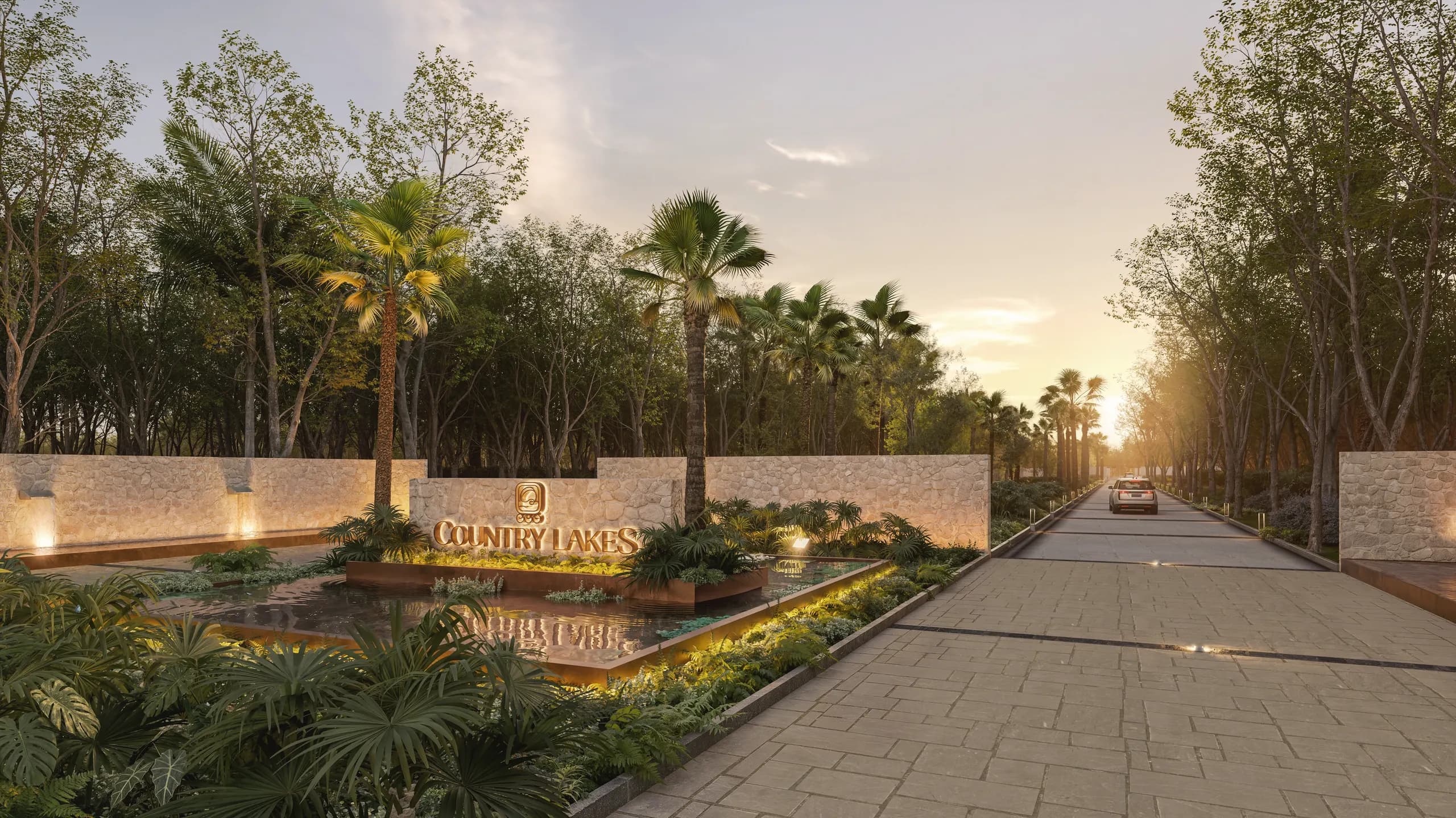 Pórtico de entrada al condominio maestro de Yucatán Country Lakes con arquitectura en piedra caliza