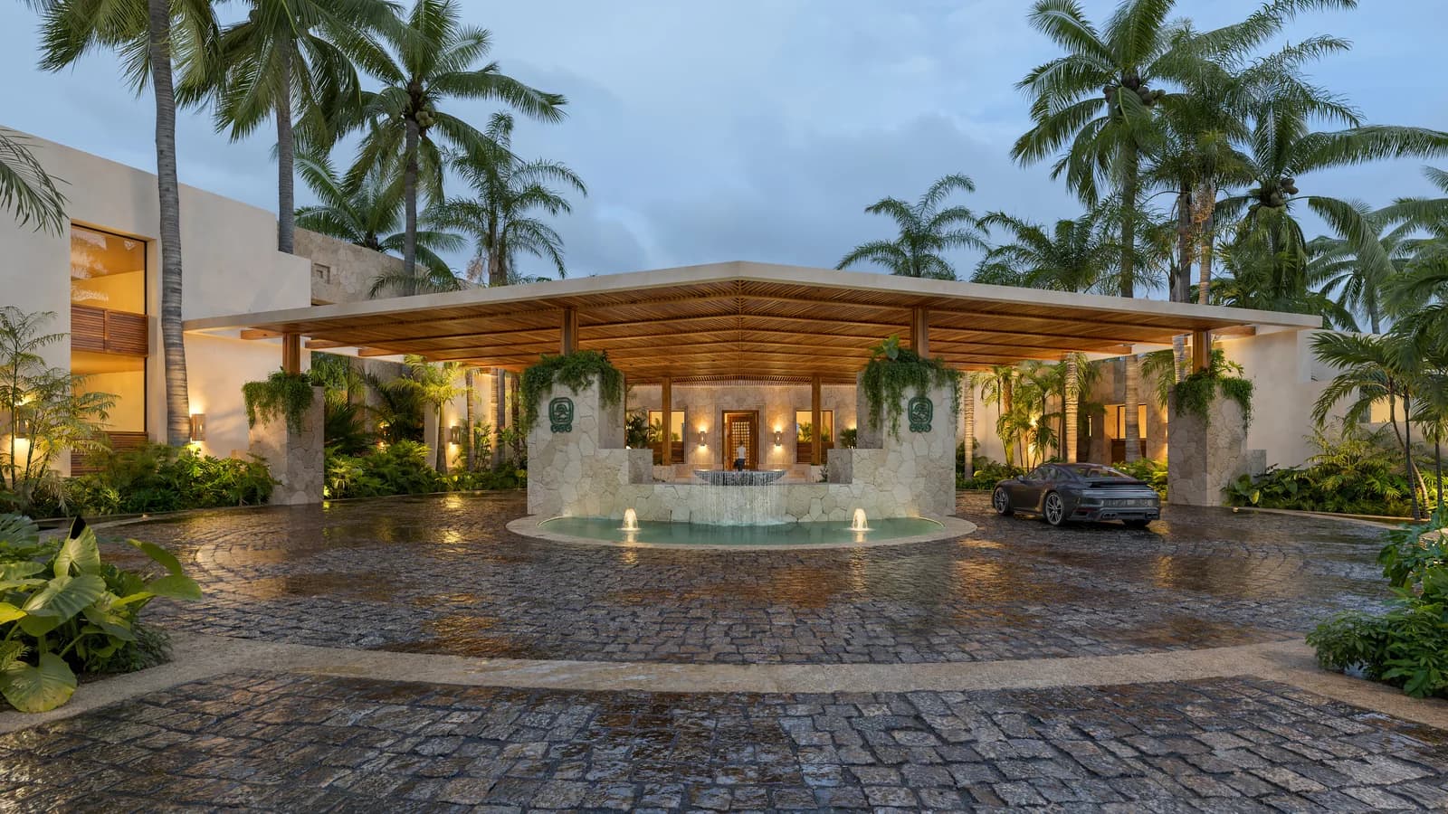 Pórtico de acceso al Golf Club de Country Lakes al anochecer — piedra, madera y fuente